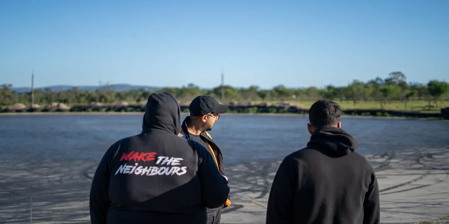Two people in WTN hoodies, backs to the camera