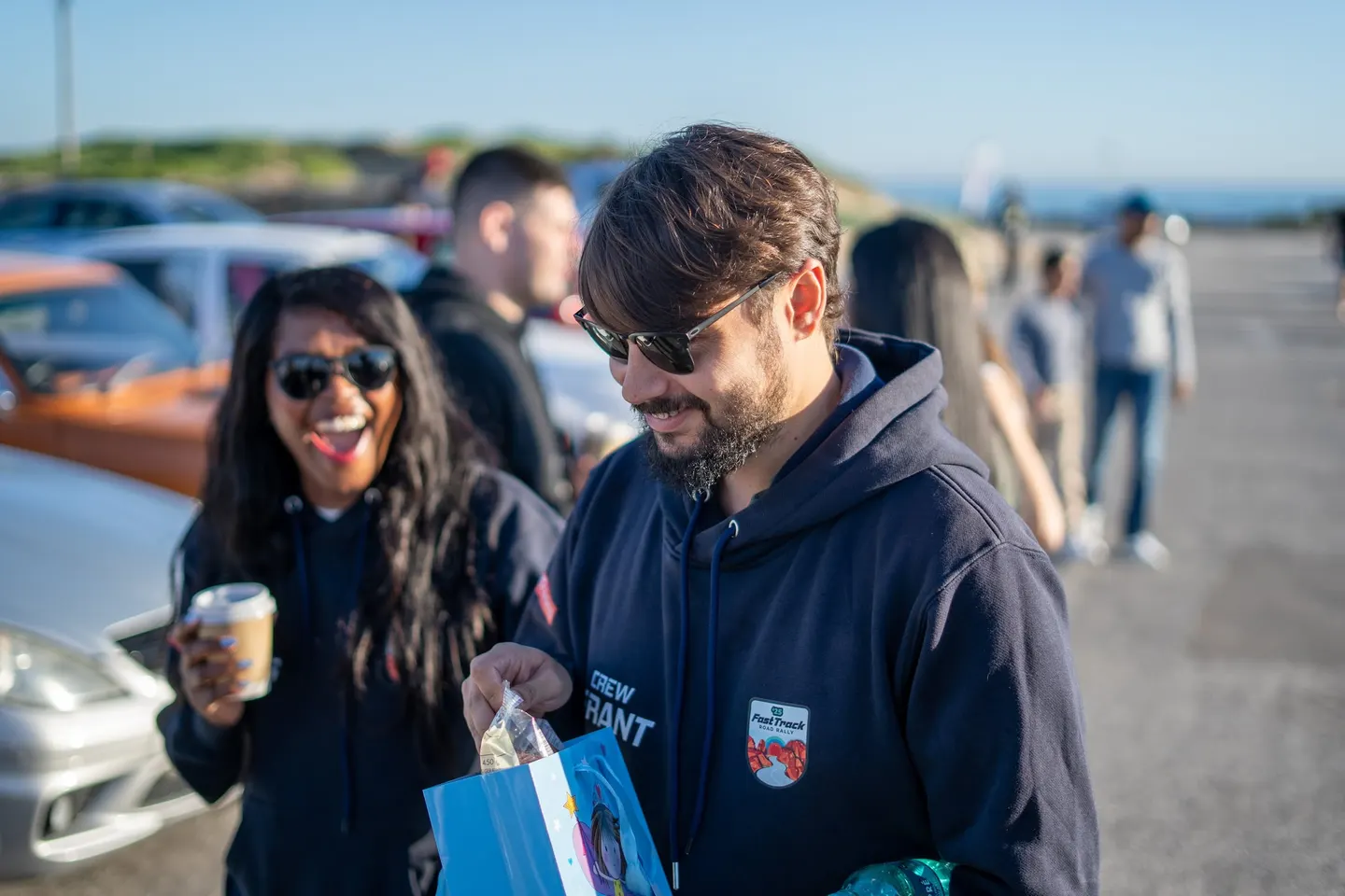Two guests laughing, coffee in hand