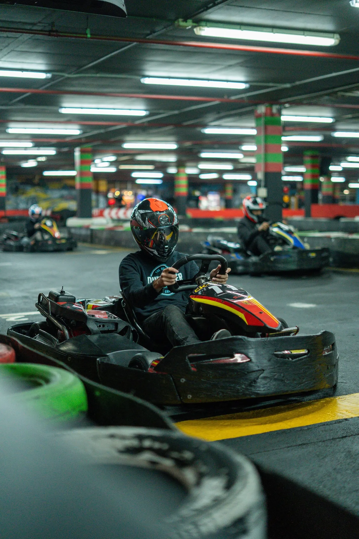 A driver turning in under the pit lights