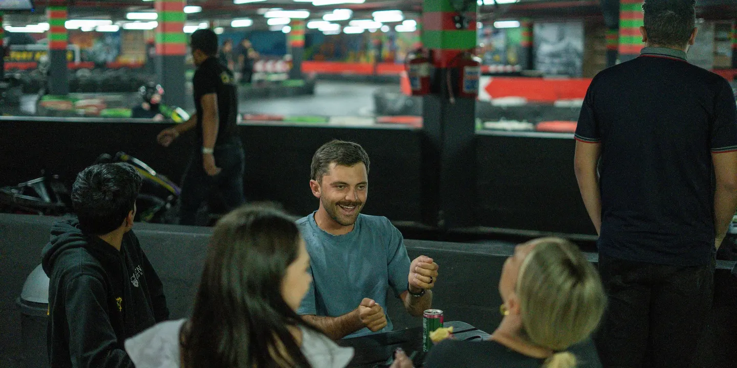 Drivers laughing over drinks between heats