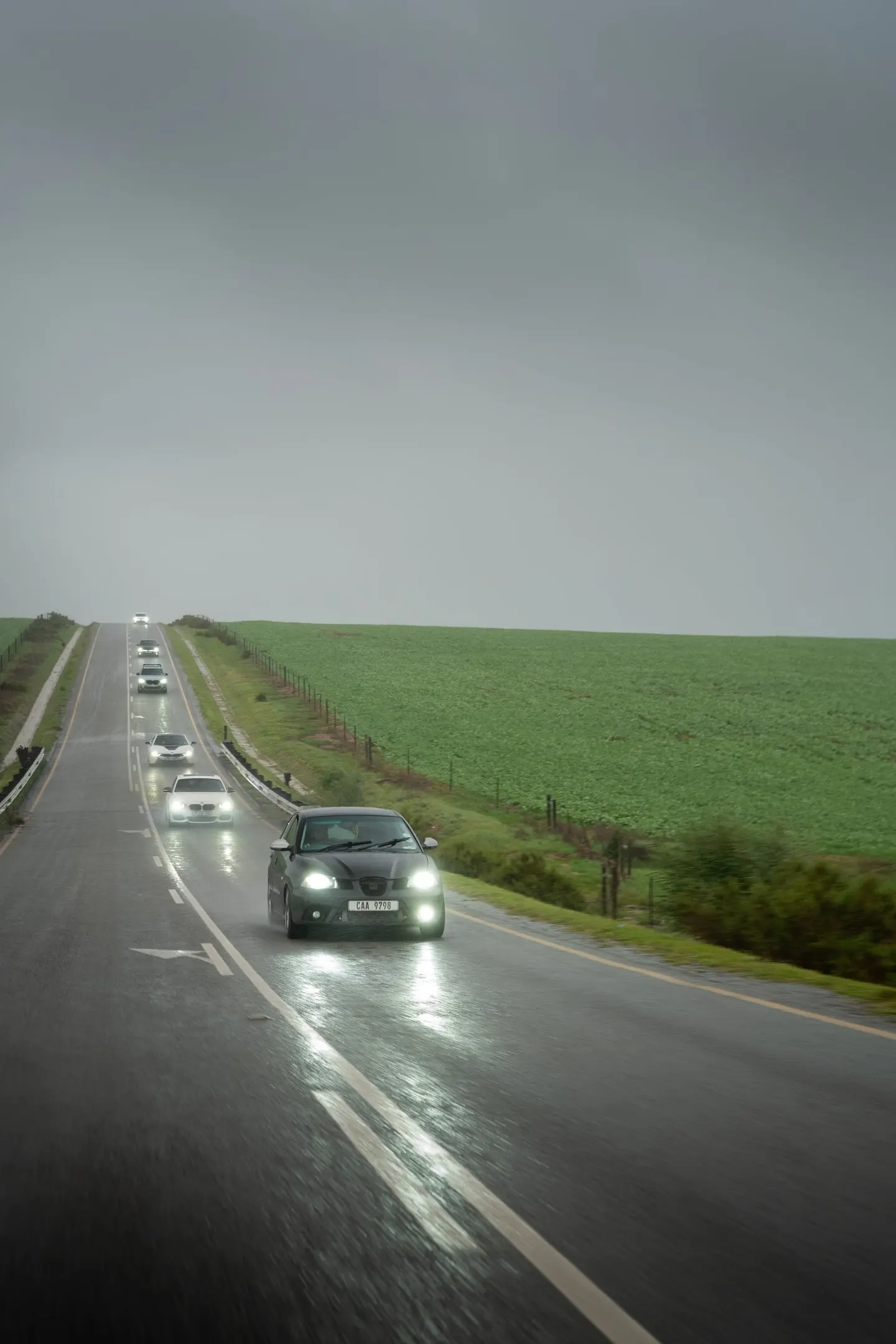 The convoy on a long, wet country road