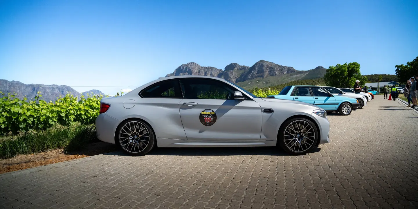 A BMW M2 parked between the vineyards at Leo Sky Farm